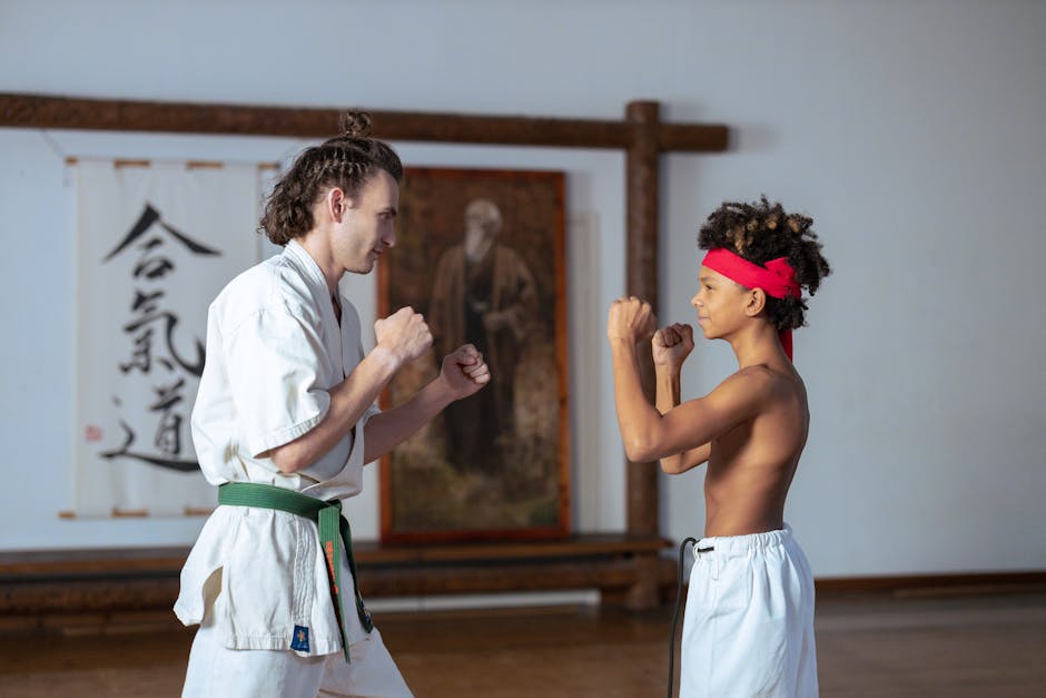 Karate instructor and student practicing martial arts techniques indoors.